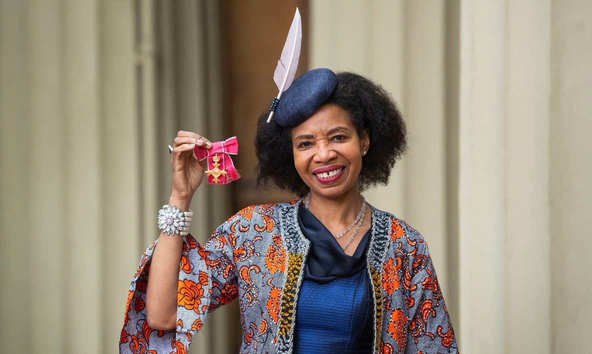 SJT-holding-up-OBE-medal-As